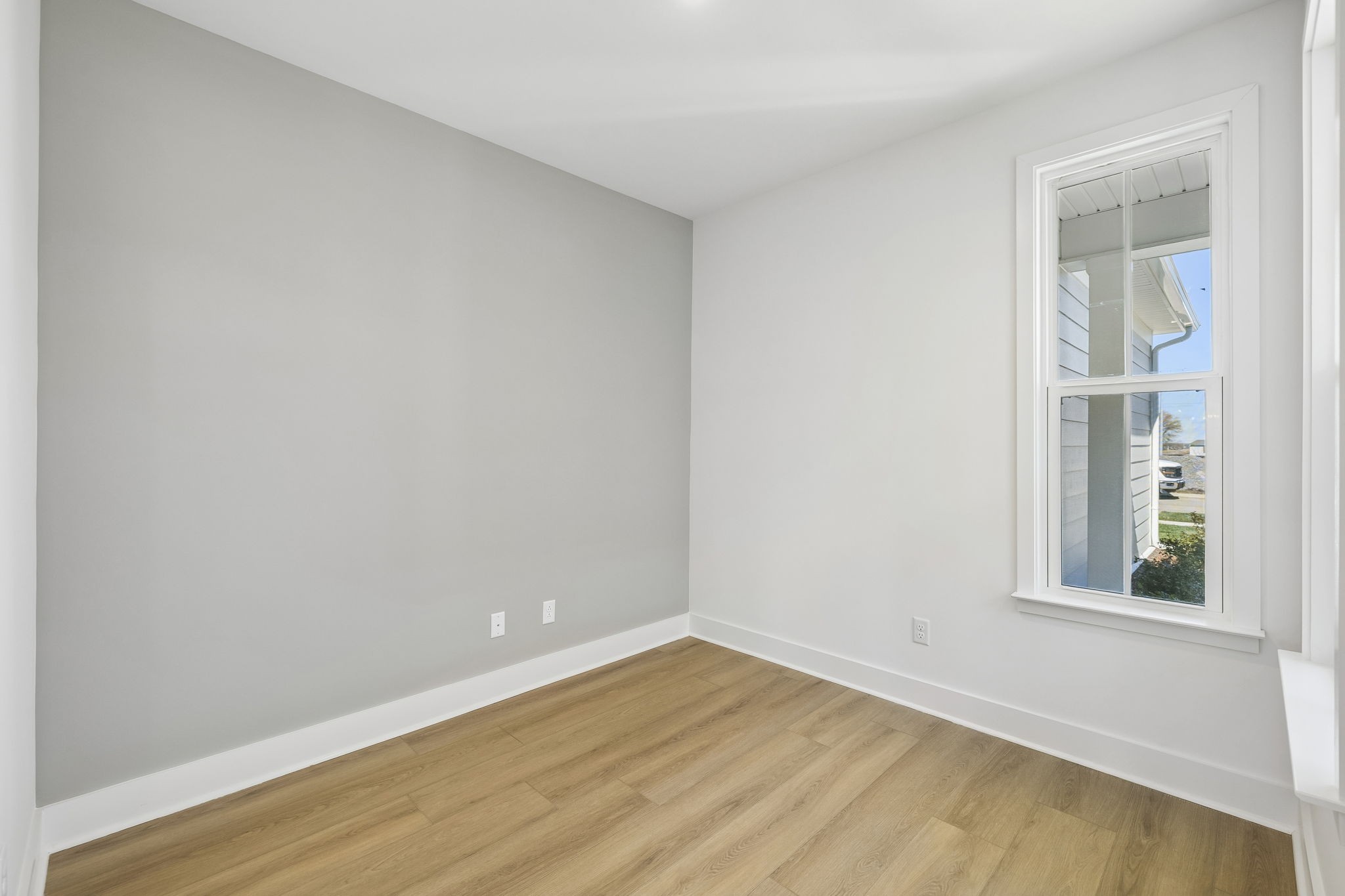 519 Scarlet Oak Road Lebanon, TN 37090 - Photo 9 of 51 a view of an empty room with wooden floor and a window