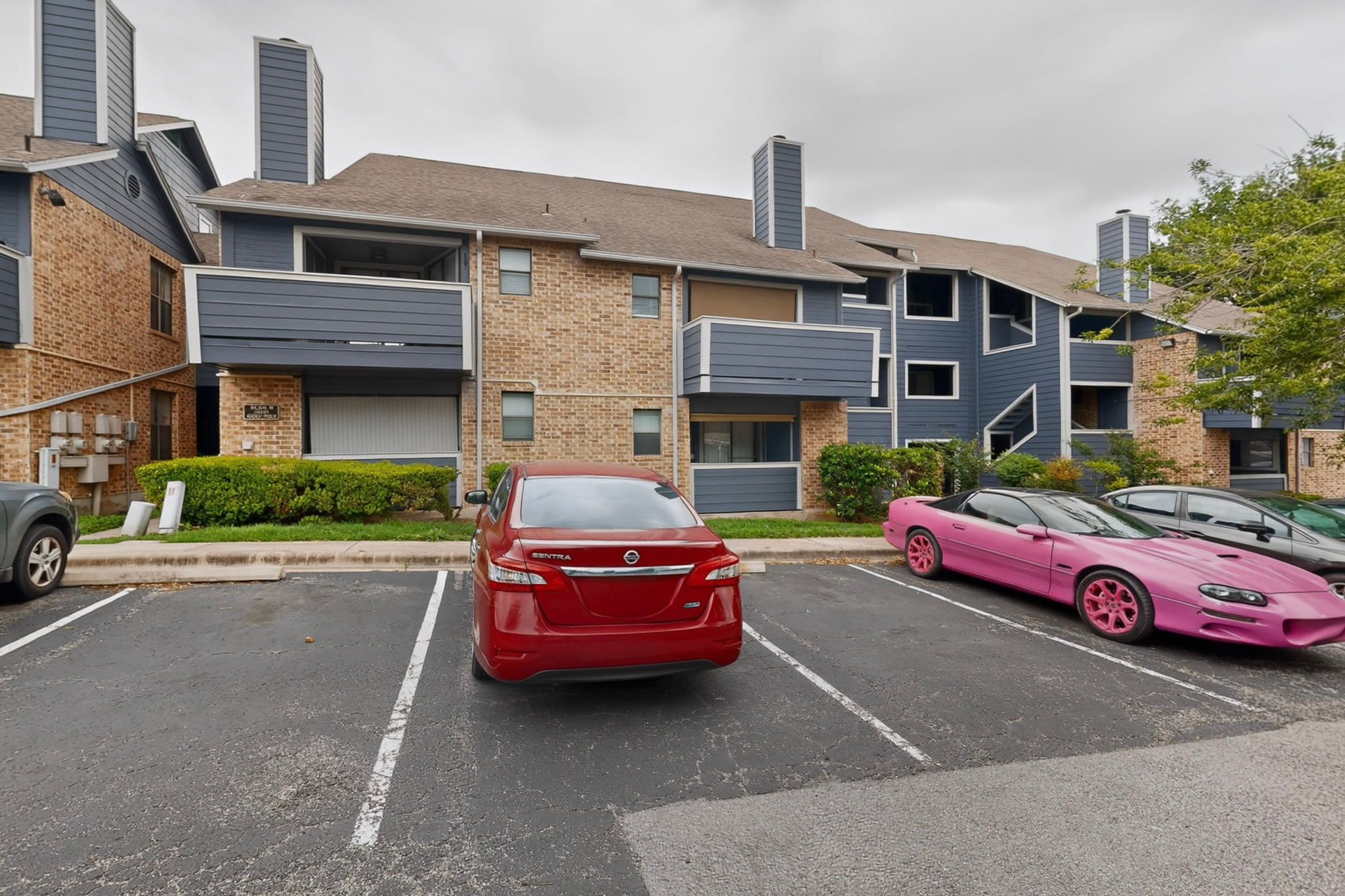 2500 Burleson Road, Unit 506 Austin, TX 78741 - Photo 26 of 29 Multi-level brick and siding exteriors feature private balconies alongside convenient paved parking areas.