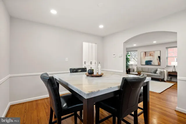 a view of a hallway with wooden floor and a cabinet