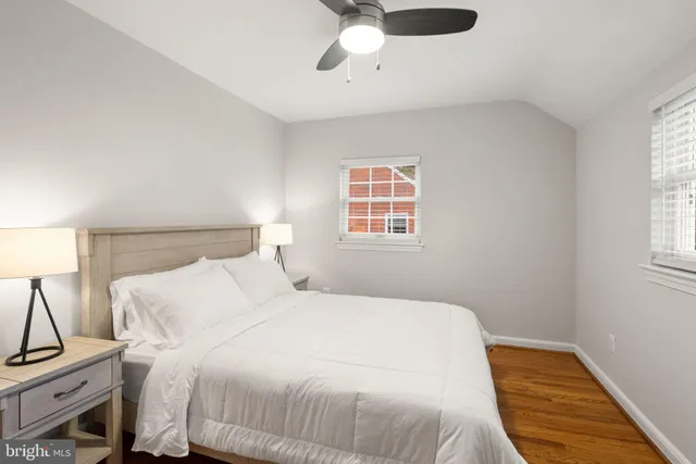 a bedroom with a bed and a potted plant