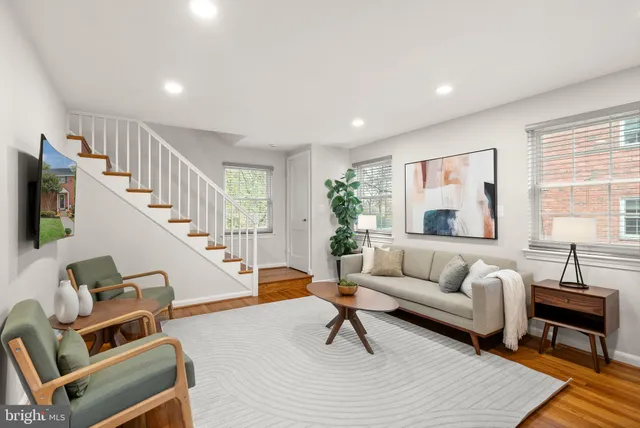 a living room with furniture and a potted plant