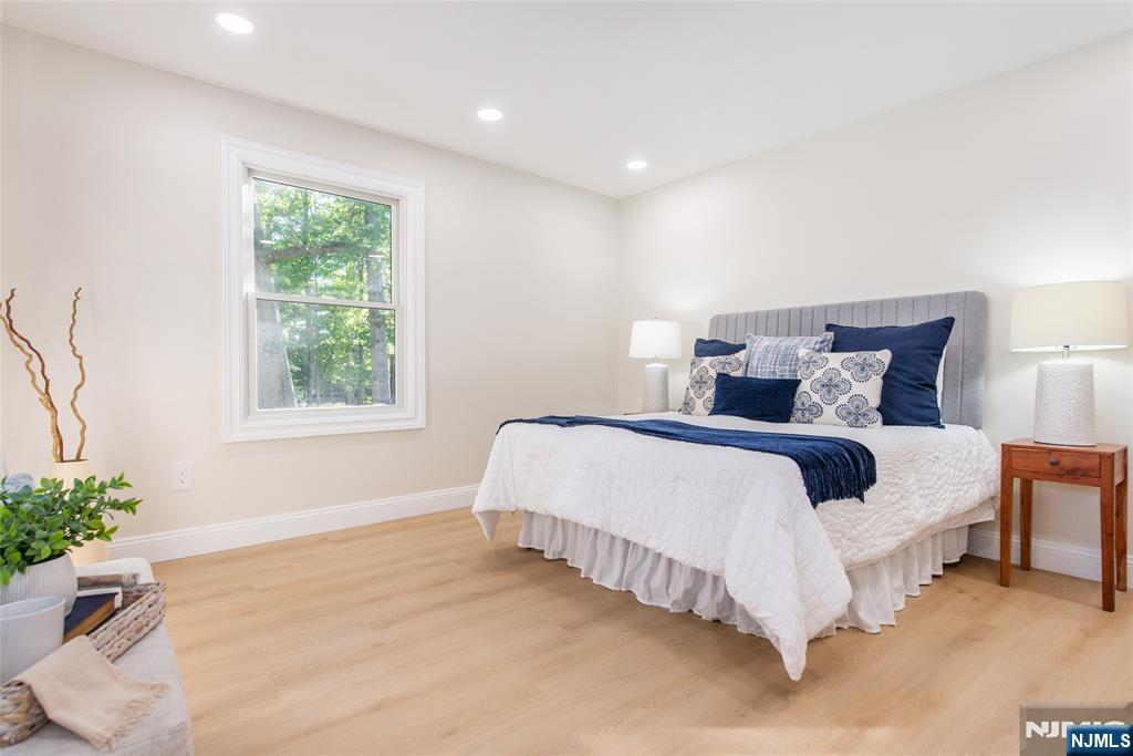 145 Grove Street Mahwah, NJ 07430 - Photo 14 of 30 a spacious bedroom with a bed and a potted plant