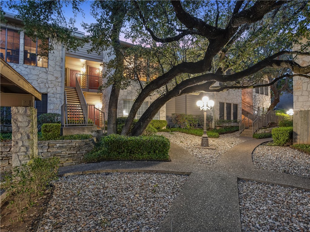 a view of a house with a tree back yard