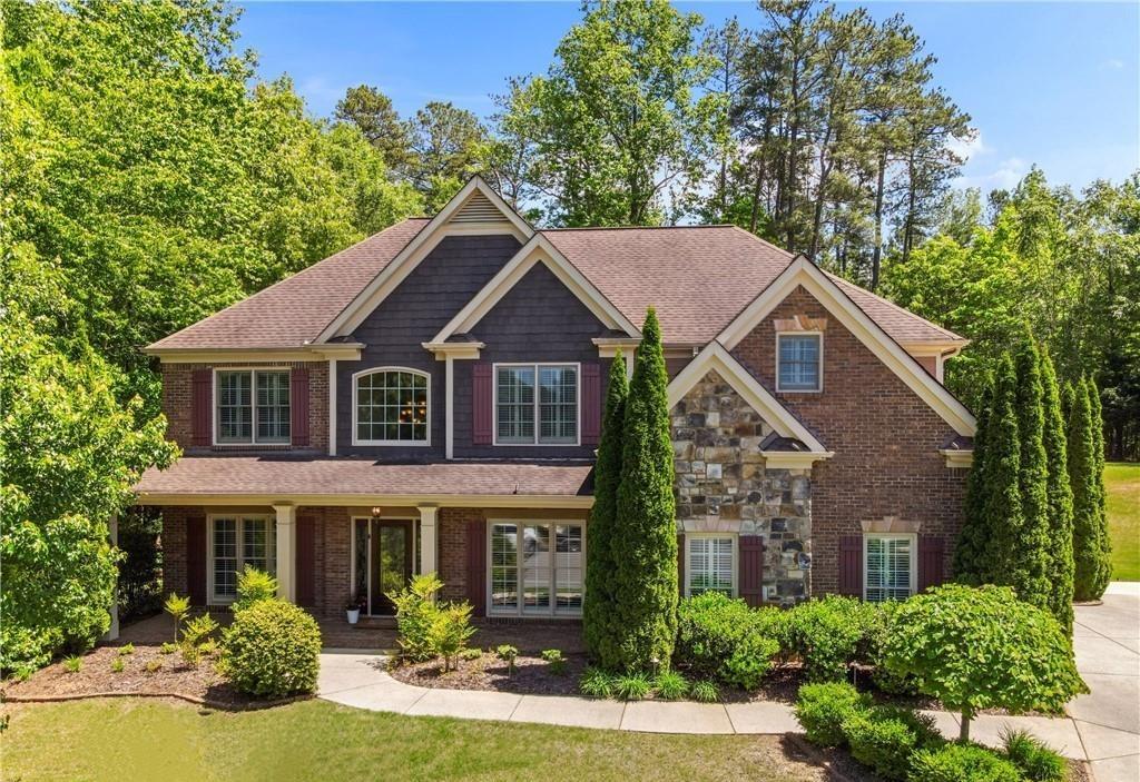 a aerial view of a house with yard and green space