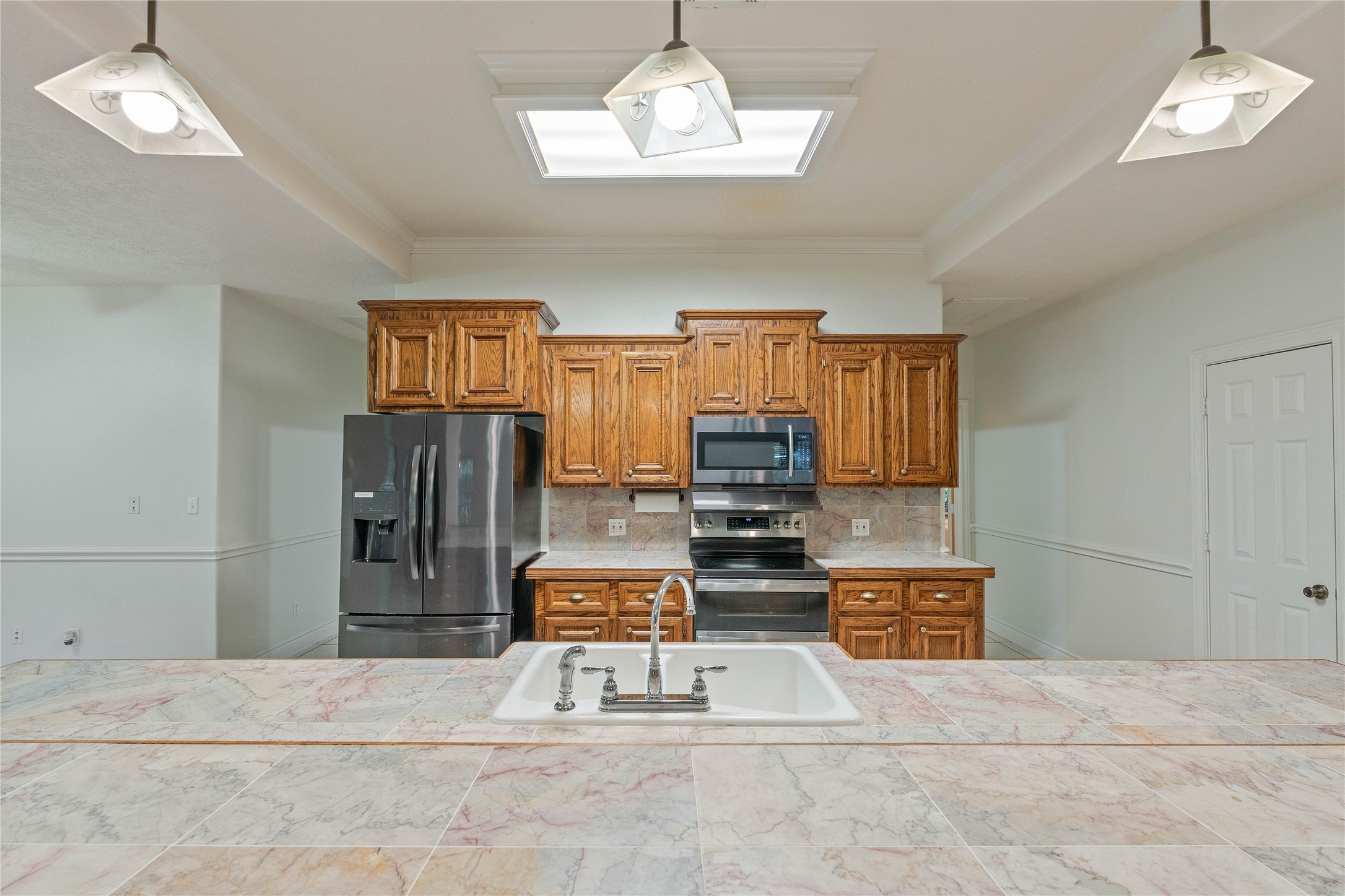 600 Hughes Loop Willis, TX 77378 - Photo 12 of 50 a living room with furniture a chandelier and a dining table with wooden floor