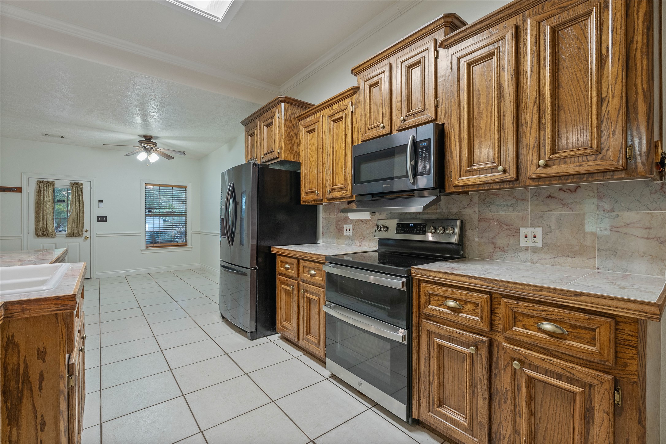 600 Hughes Loop Willis, TX 77378 - Photo 14 of 50 a kitchen with stainless steel appliances granite countertop a refrigerator and cabinets