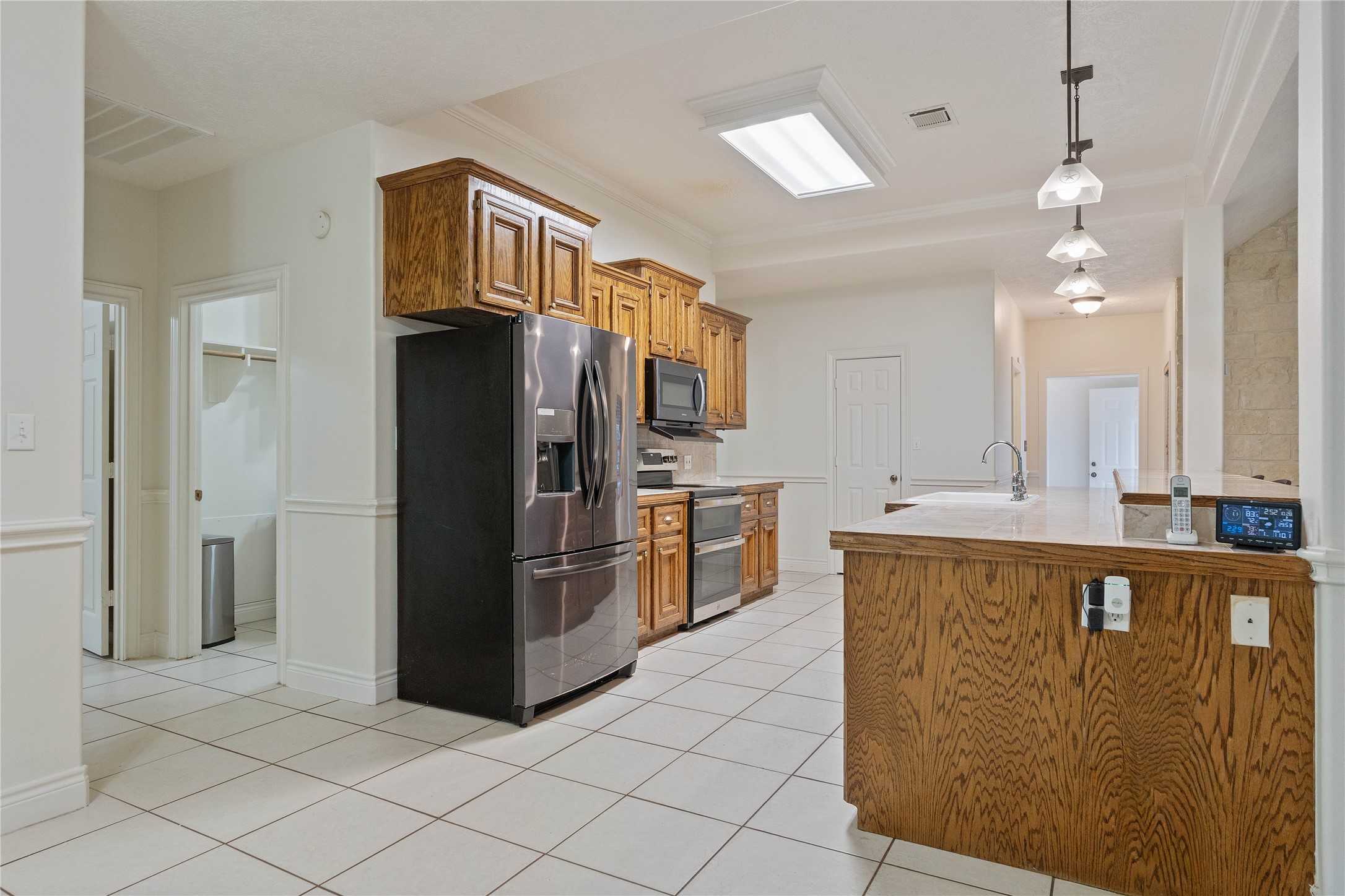 600 Hughes Loop Willis, TX 77378 - Photo 15 of 50 a kitchen with stainless steel appliances granite countertop a refrigerator a sink and dishwasher