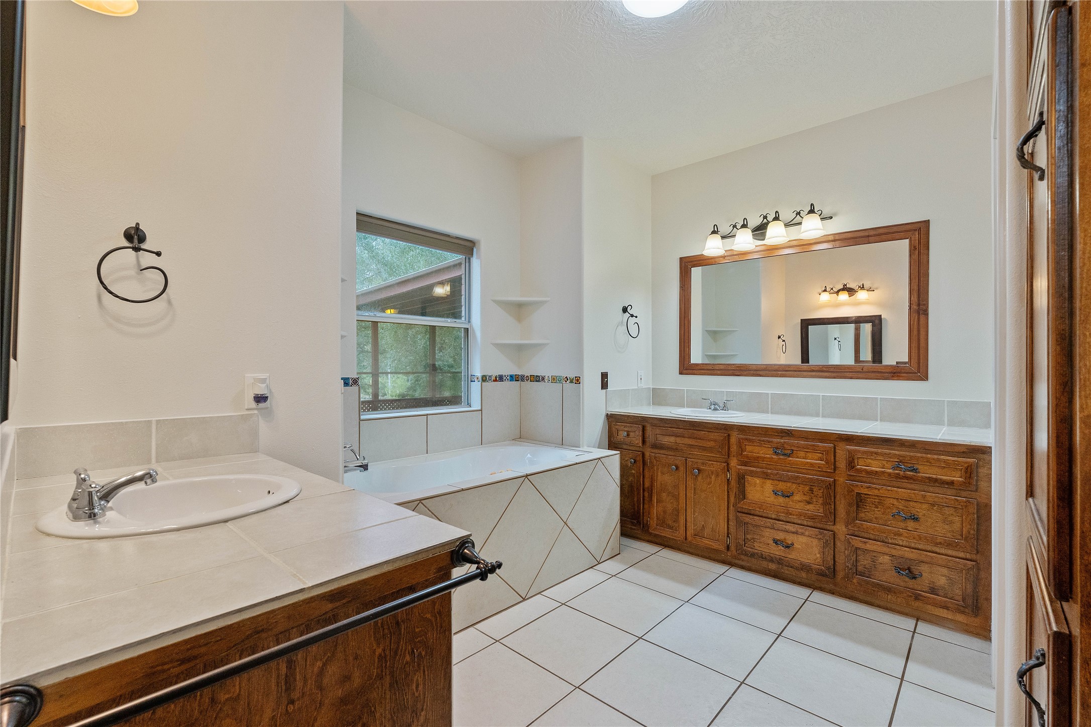 600 Hughes Loop Willis, TX 77378 - Photo 19 of 50 a spacious bathroom with a granite countertop sink and a mirror