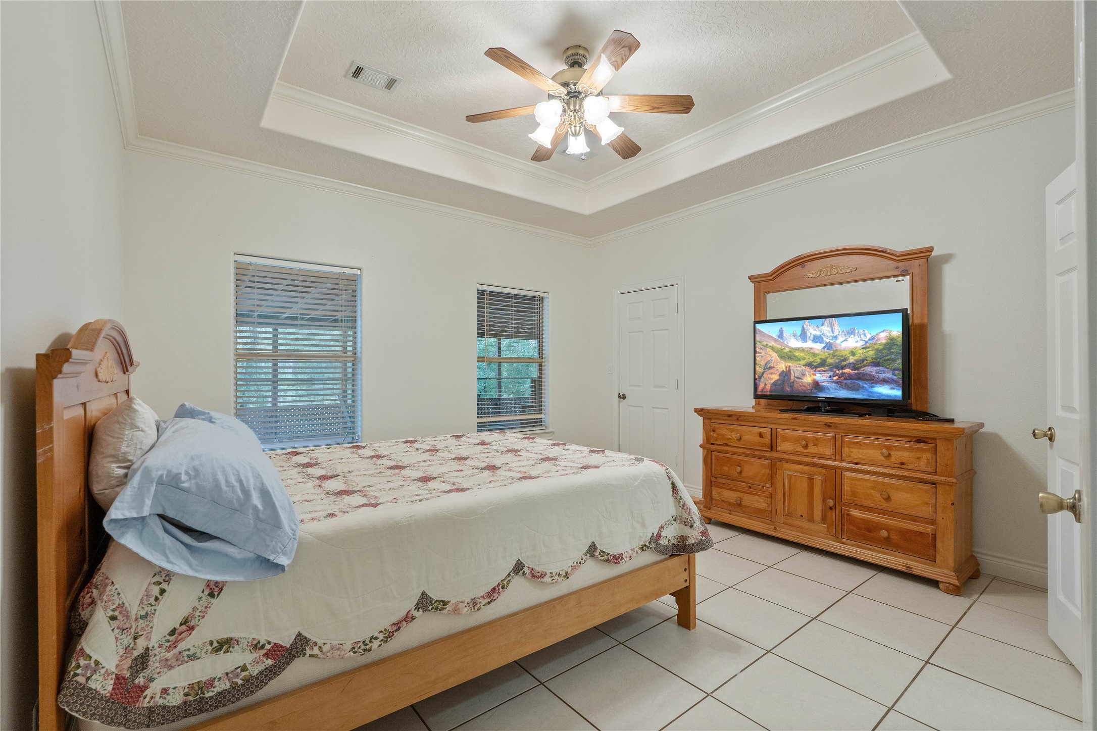 600 Hughes Loop Willis, TX 77378 - Photo 22 of 50 a bedroom with a bed and a chandelier