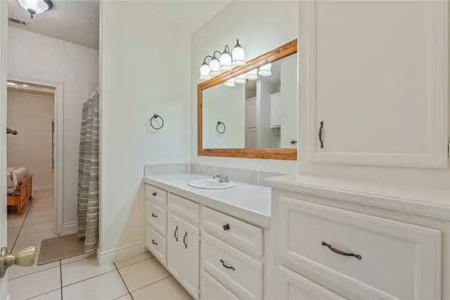 a view of a hallway with wooden cabinets