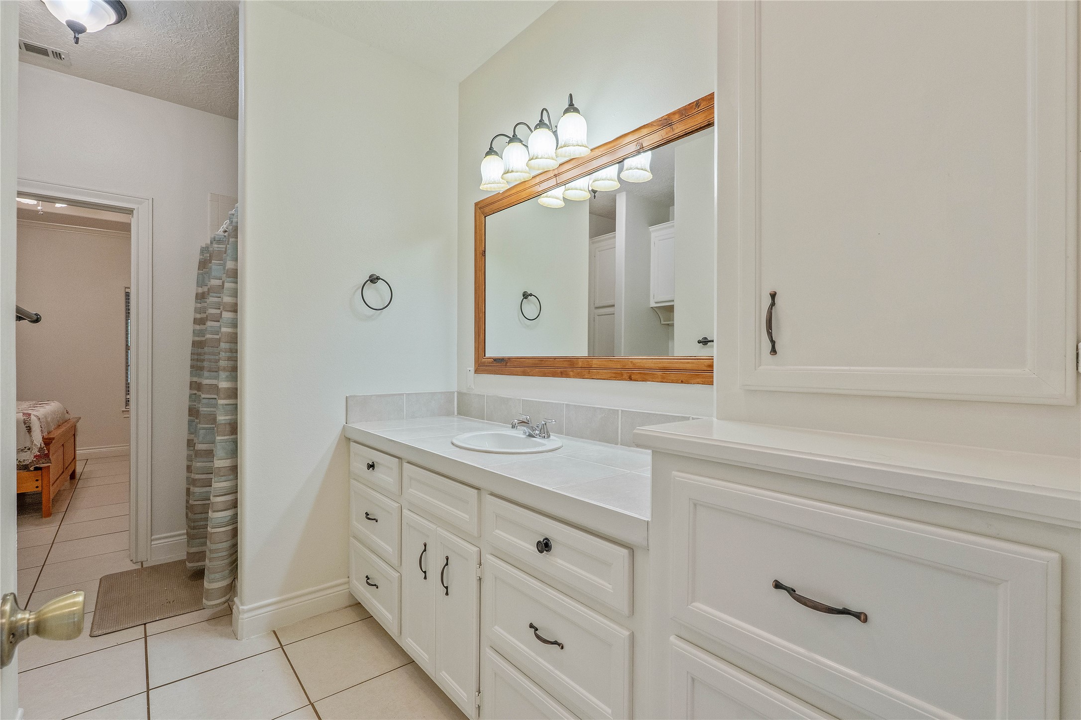 600 Hughes Loop Willis, TX 77378 - Photo 24 of 50 a bathroom with a sink and a mirror
