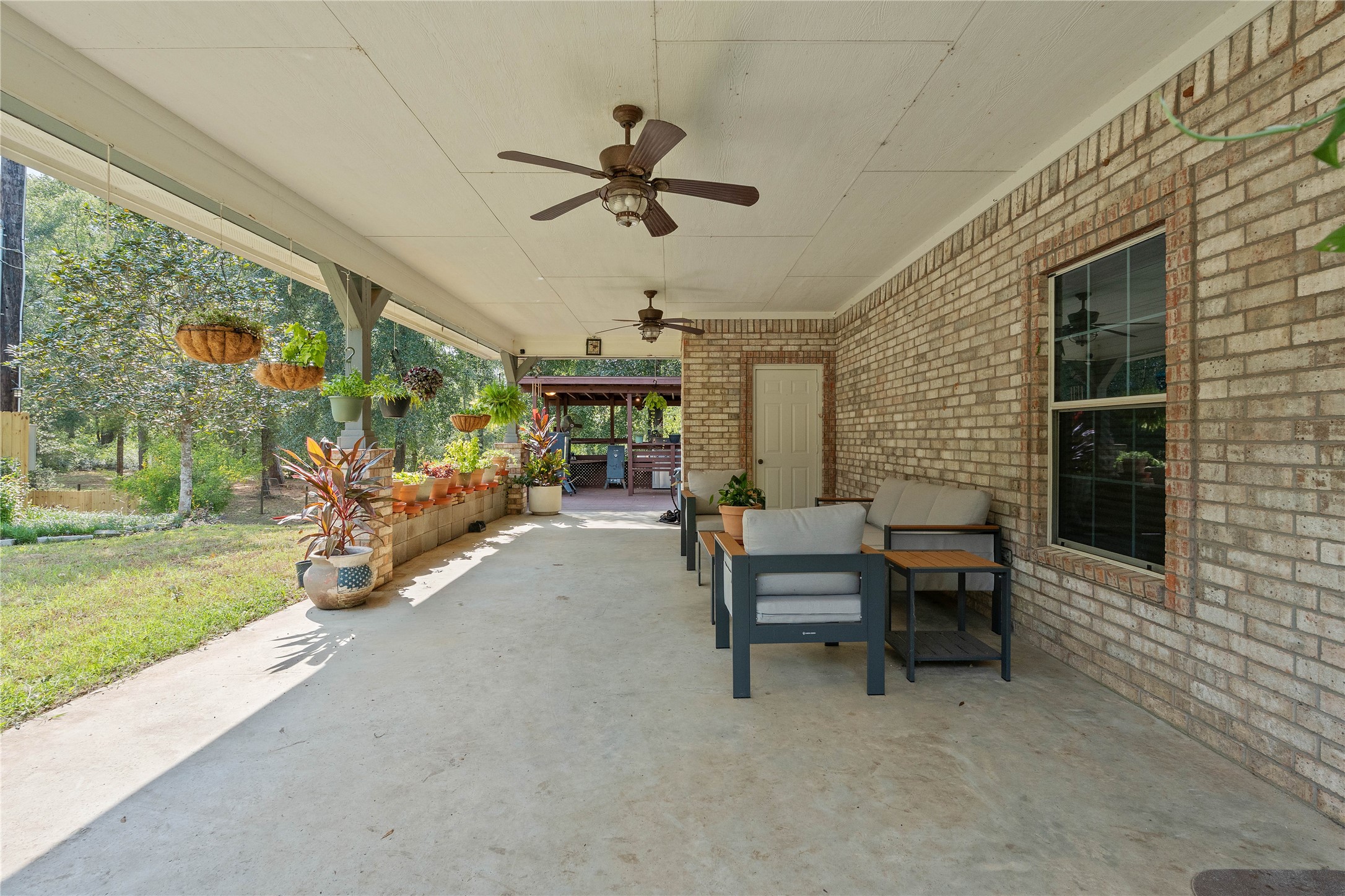600 Hughes Loop Willis, TX 77378 - Photo 29 of 50 a view of a porch with dining table and chairs