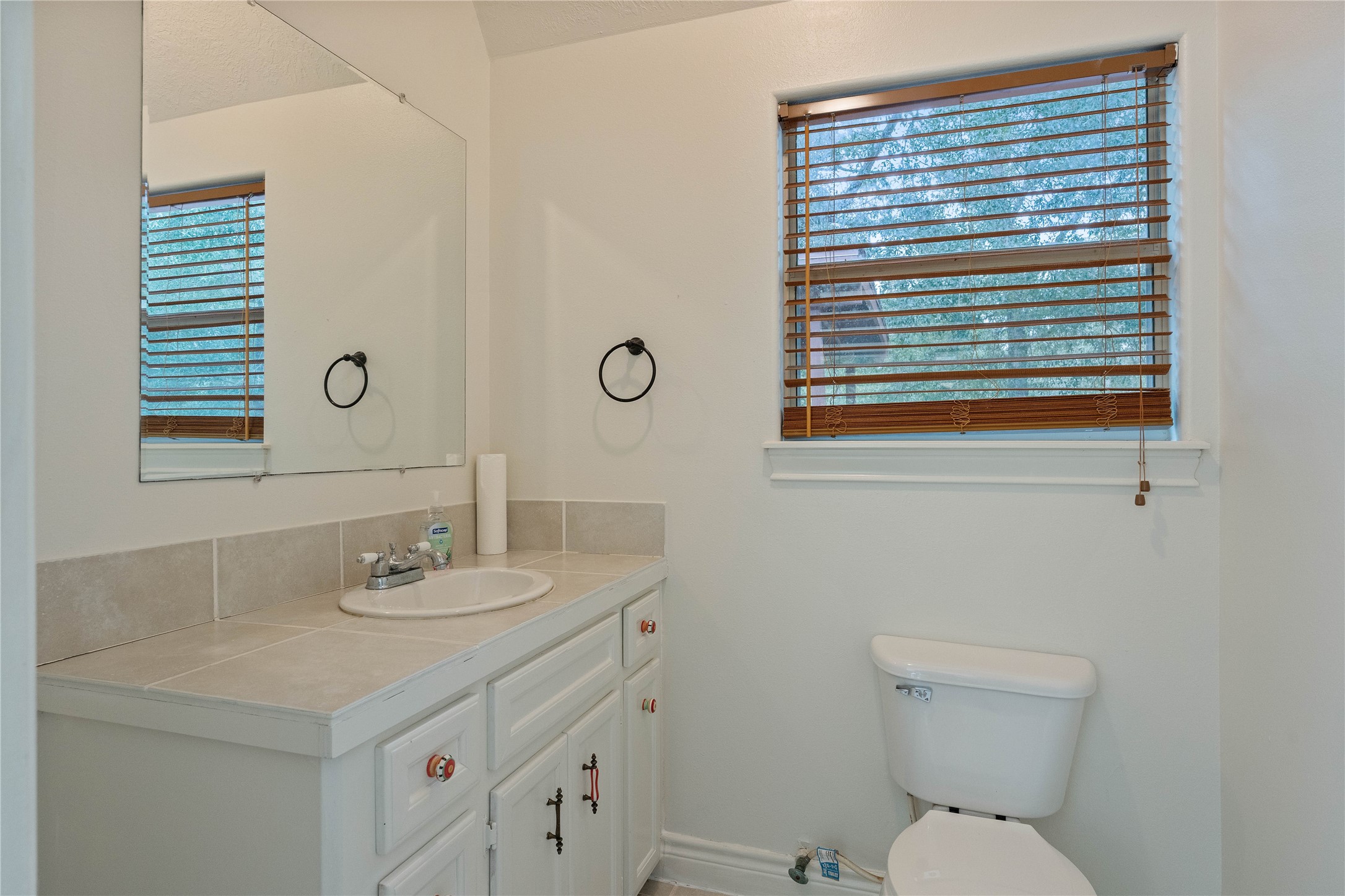 600 Hughes Loop Willis, TX 77378 - Photo 31 of 50 a bathroom with a sink a toilet and a mirror