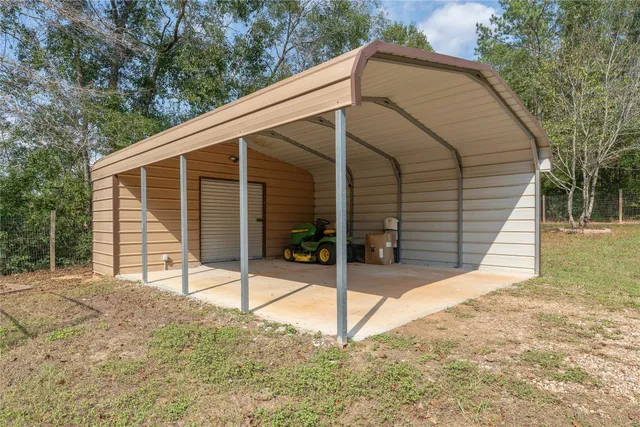 a view of a house with a patio and a yard