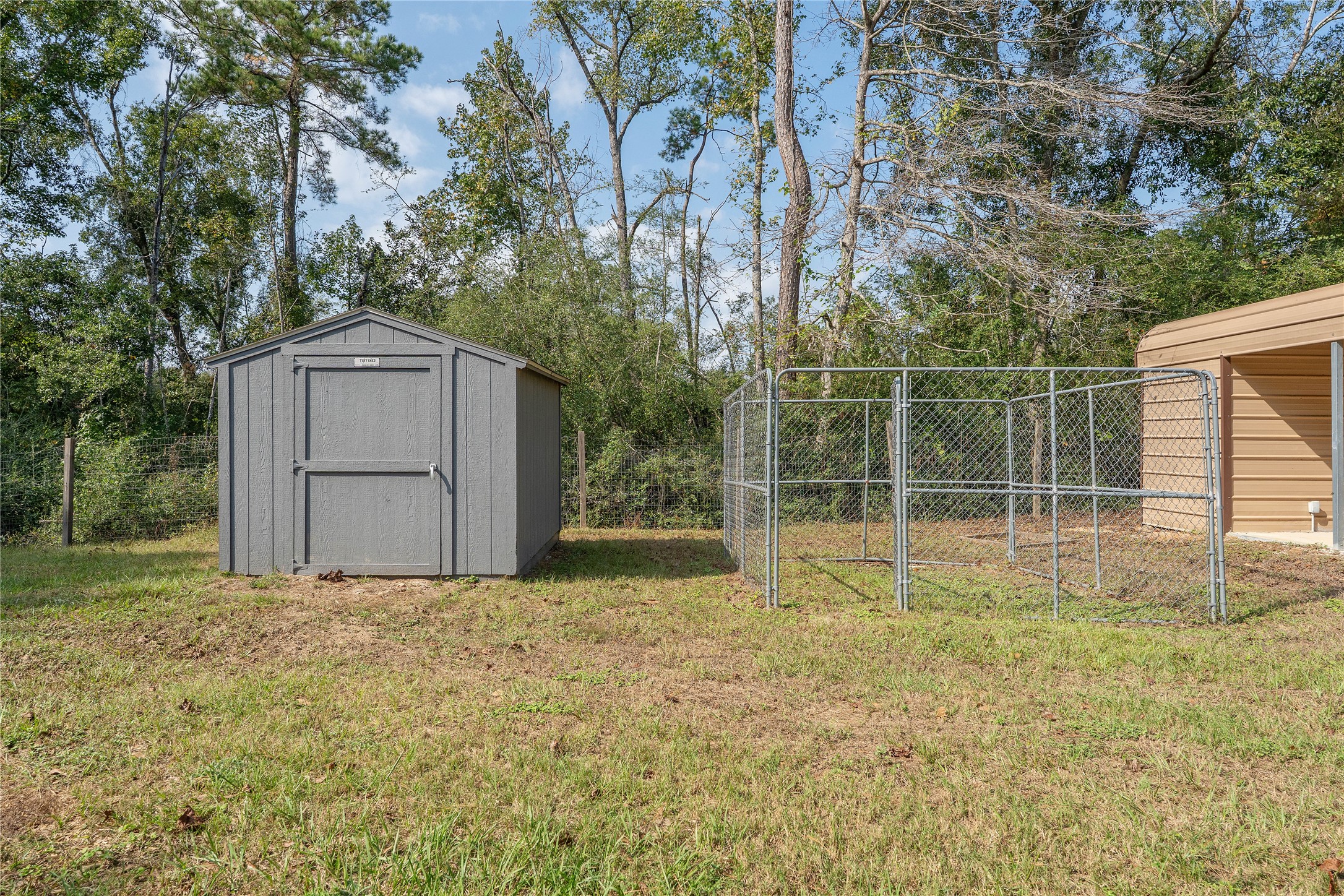 600 Hughes Loop Willis, TX 77378 - Photo 41 of 50 a backyard of a house with plants and large trees