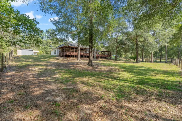 a aerial view of a house with yard and patio