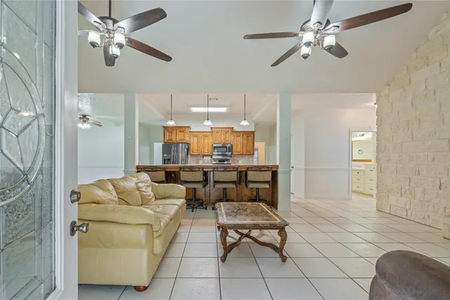 a living room with furniture a ceiling fan and a rug