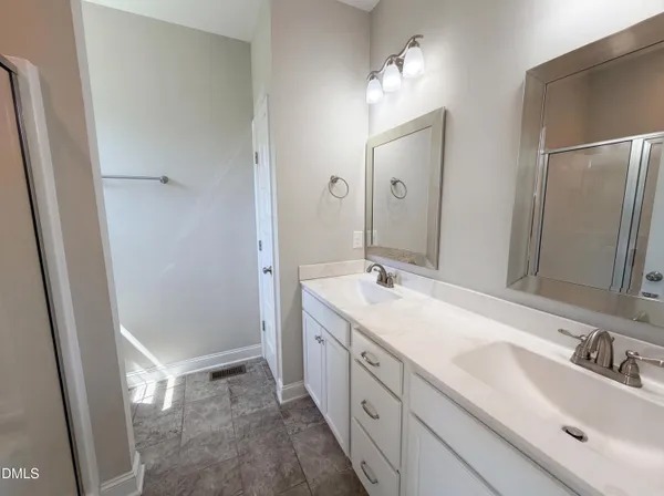 a bathroom with a double vanity sink mirror and double