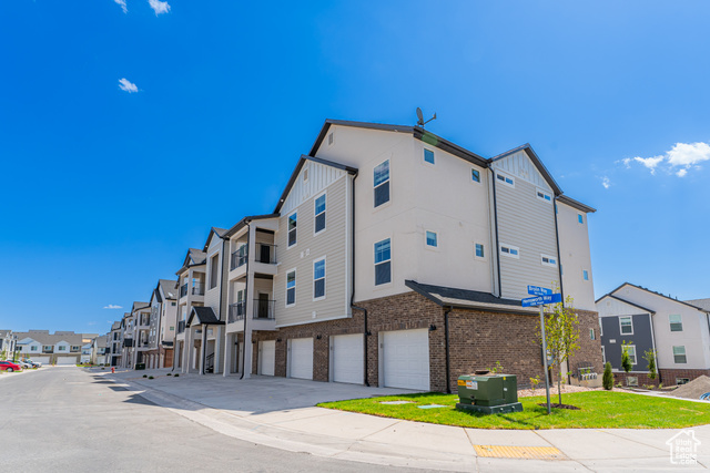 874 Hemsworth Way, Unit R101 Saratoga Springs, UT 84045 - Photo 1 of 1 View of property featuring a residential view, driveway, and a garage