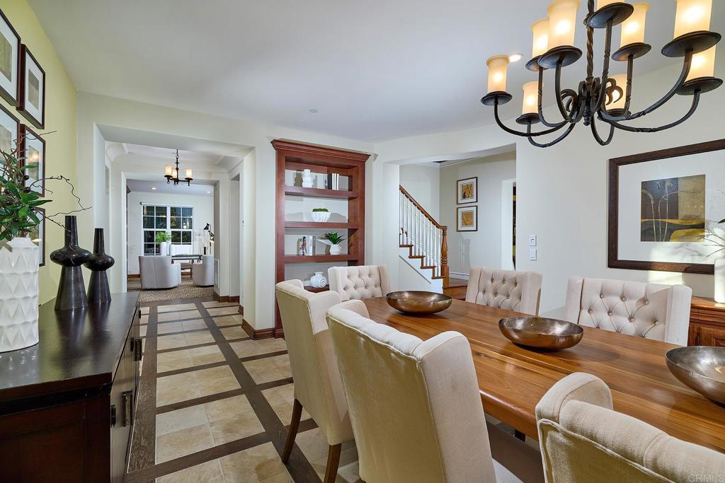 6591 Halite Place Carlsbad, CA 92009 - Photo 16 of 33 a living room with furniture a chandelier and a flat screen tv