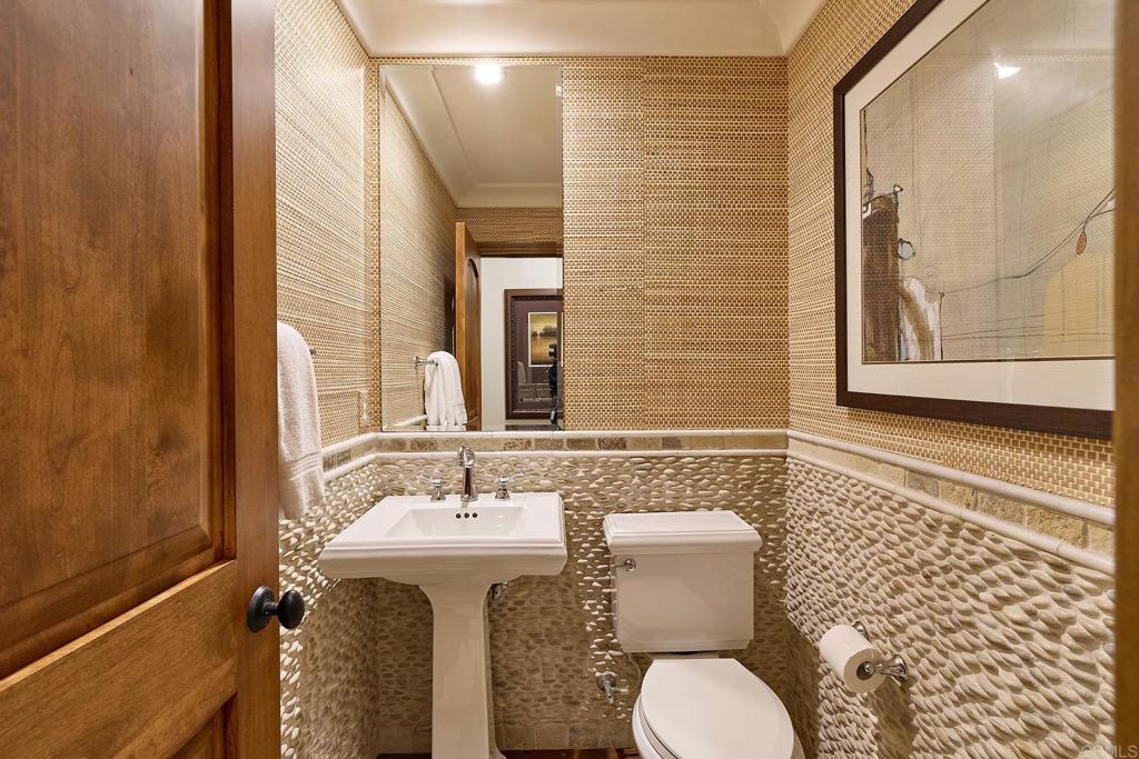 6591 Halite Place Carlsbad, CA 92009 - Photo 18 of 33 a bathroom with a sink and mirror with toilet