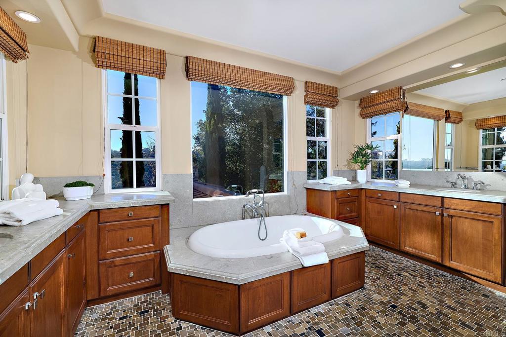 6591 Halite Place Carlsbad, CA 92009 - Photo 22 of 33 a kitchen with stainless steel appliances granite countertop a sink and wooden cabinets