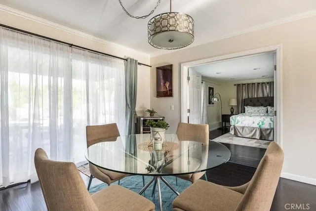 a view of a dining room with furniture wooden floor and chandelier