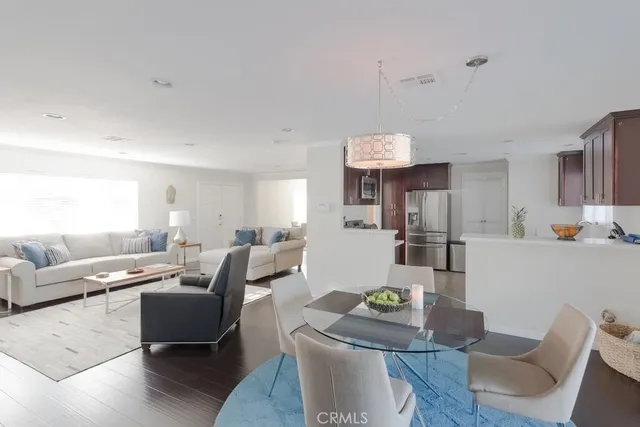 a living room with furniture and kitchen view