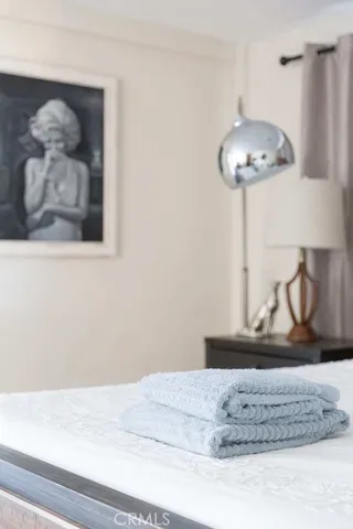 a bedroom with a bed and a painting on the wall