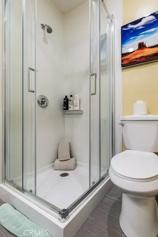 a bathroom with a toilet and a shower