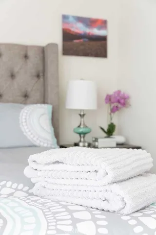 a bedroom with a bed and a painting on the wall