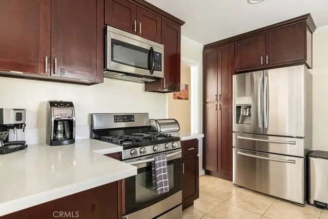 a kitchen with stainless steel appliances granite countertop a refrigerator stove and microwave