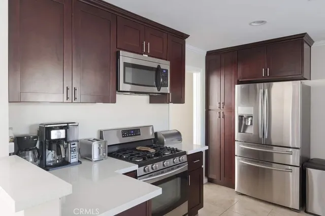 a kitchen with stainless steel appliances granite countertop a refrigerator stove and microwave