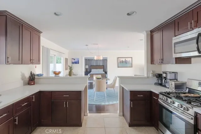 a kitchen with stainless steel appliances granite countertop a stove a sink and a microwave