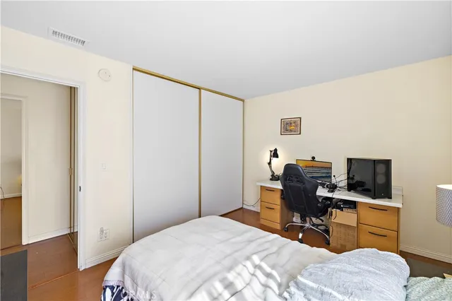 a bedroom with a bed and a desk