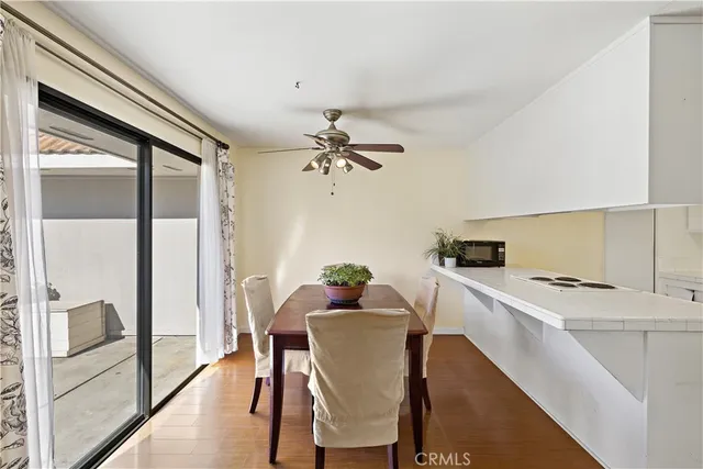 a kitchen with a dining table chairs refrigerator and cabinets