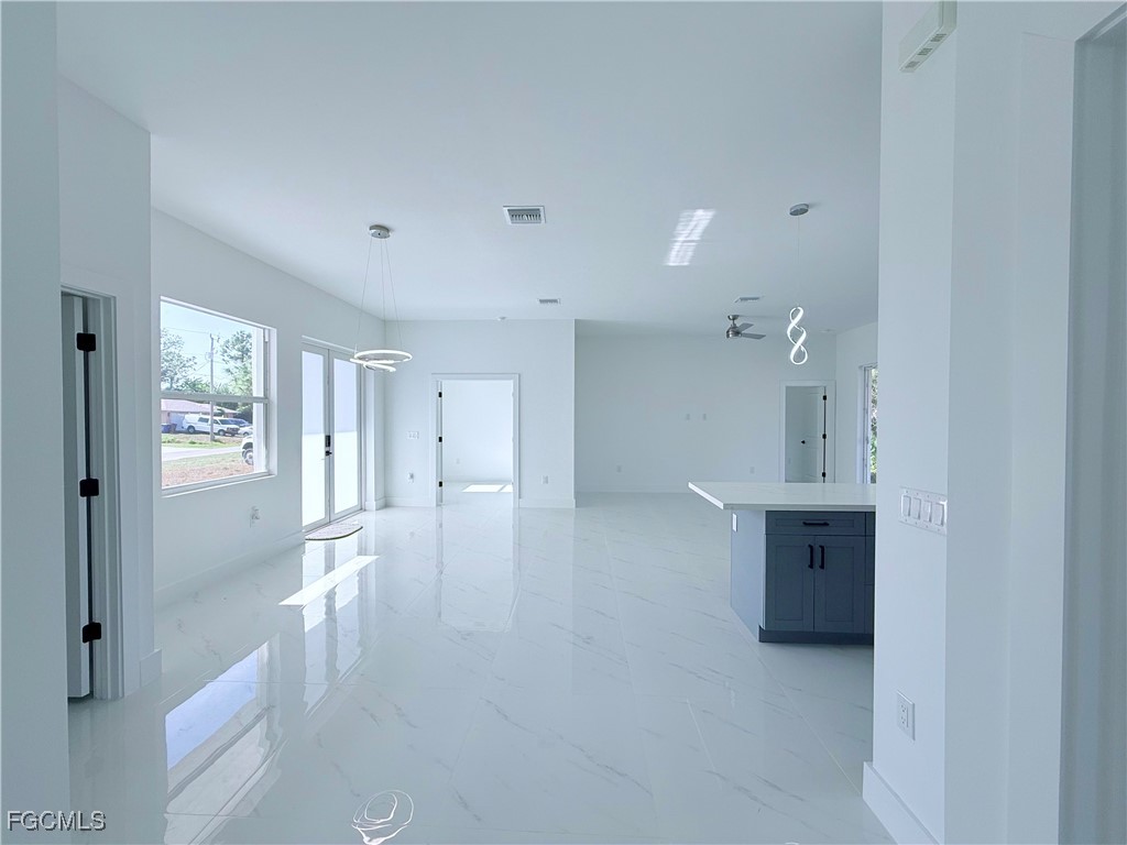 4006 2nd Street Southwest Lehigh Acres, FL 33976 - Photo 12 of 29 a view of empty room with wooden floor and window