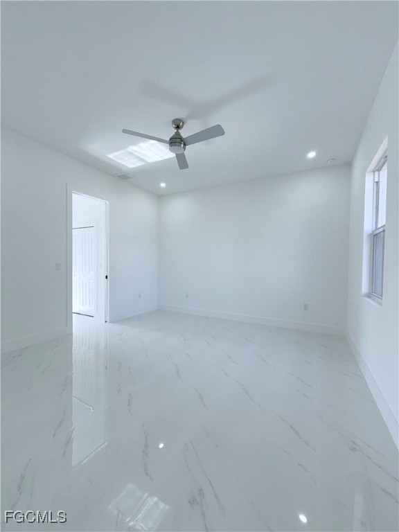 4006 2nd Street Southwest Lehigh Acres, FL 33976 - Photo 14 of 29 an empty room with a ceiling fan and window