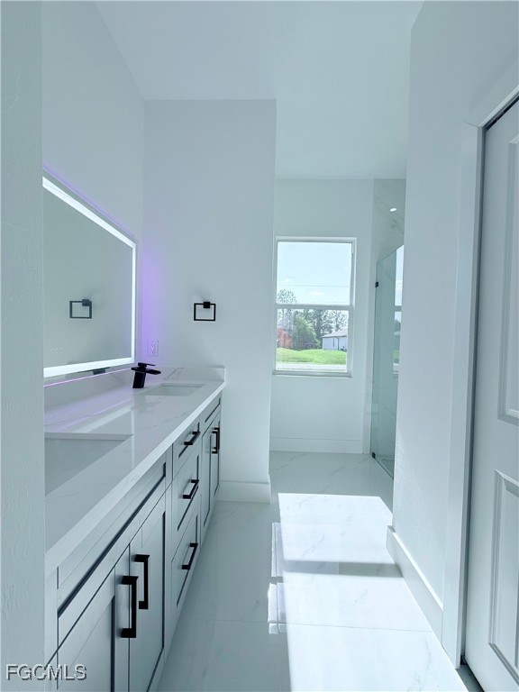 4006 2nd Street Southwest Lehigh Acres, FL 33976 - Photo 15 of 29 a bathroom with a double vanity sink and a mirror