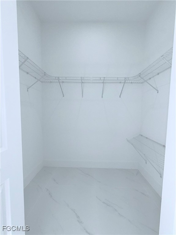 4006 2nd Street Southwest Lehigh Acres, FL 33976 - Photo 18 of 29 a view of a room with racks on the wall