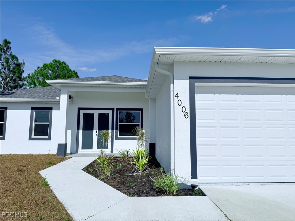 4006 2nd Street Southwest Lehigh Acres, FL 33976 - Photo 2 of 29 a front view of a house with garden