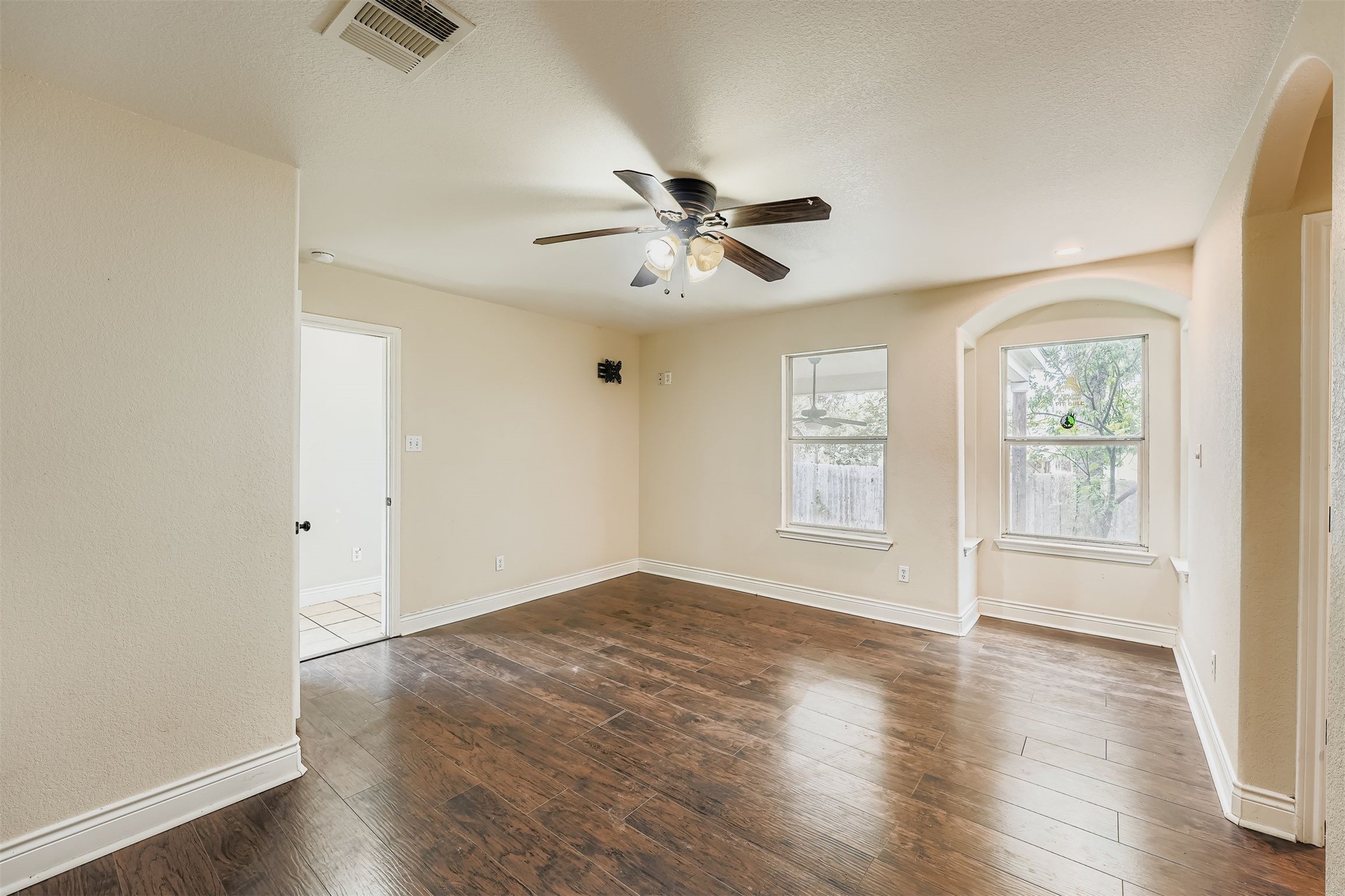 304 South Main Street Elgin, TX 78621 - Photo 17 of 25 Unfurnished room with dark wood-type flooring and a ceiling fan