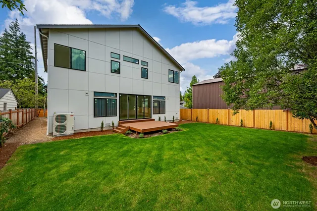 a view of a house with a yard and sitting area