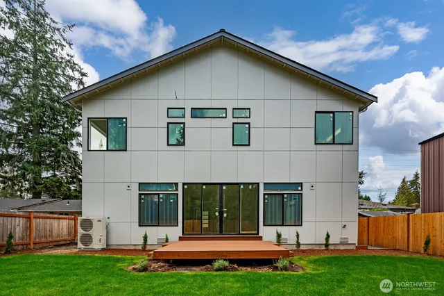 a view of a house with backyard and porch