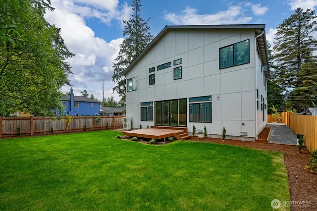 a view of a house with a yard and sitting area
