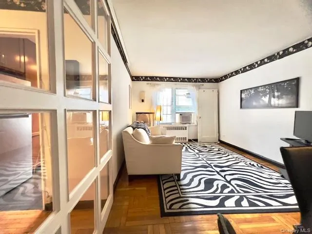 a living room with furniture and a floor to ceiling window