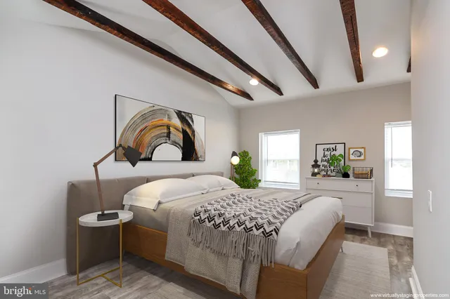 a bedroom with a large bed and a painting on the wall