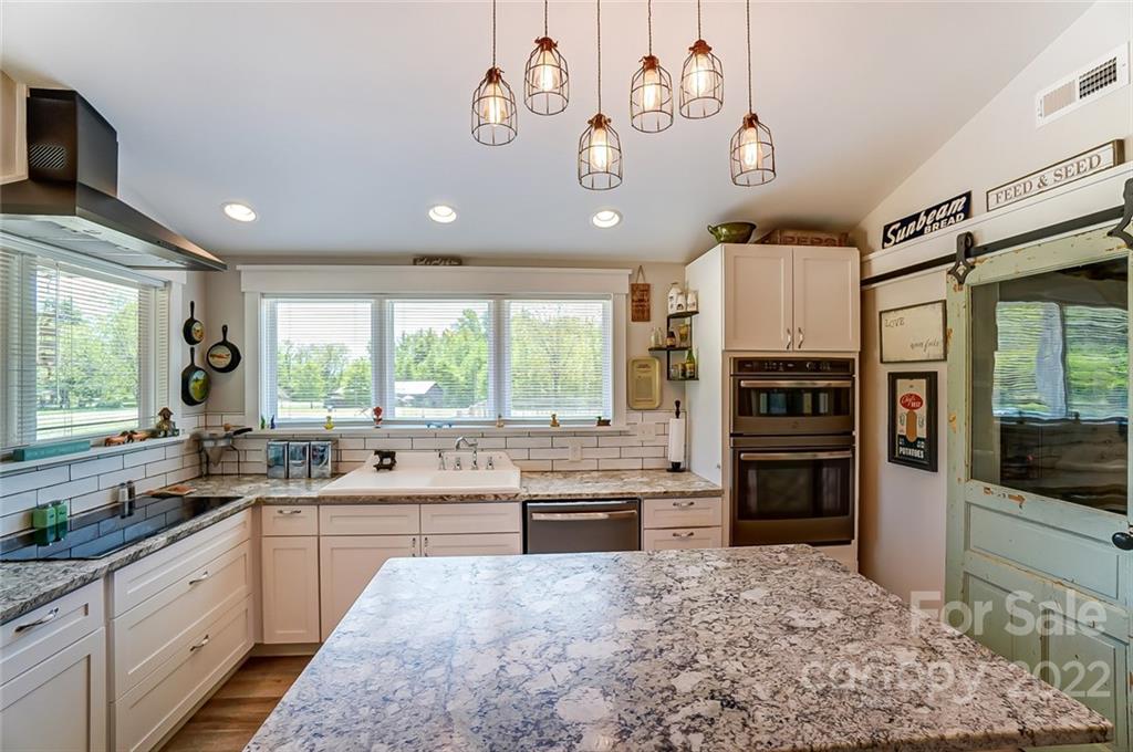6250 Faith Road Salisbury, NC 28146 - Photo 11 of 38 a large kitchen with a large window and stainless steel appliances