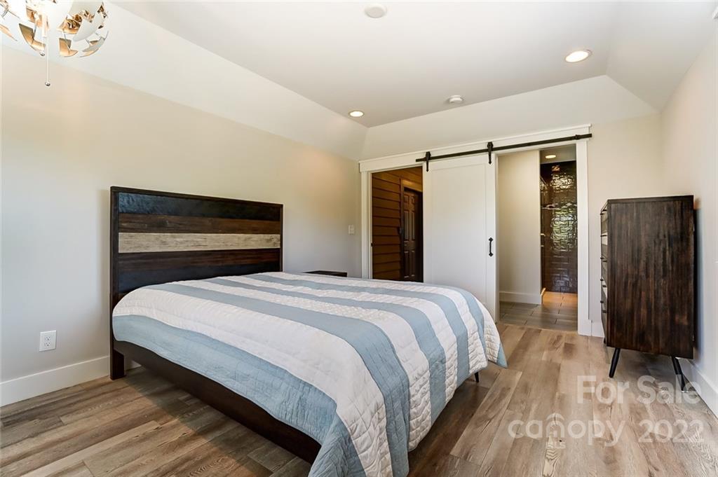 6250 Faith Road Salisbury, NC 28146 - Photo 18 of 38 a bedroom with a bed and wooden floor