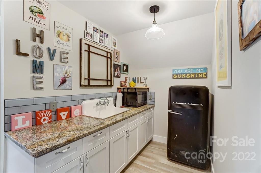 6250 Faith Road Salisbury, NC 28146 - Photo 20 of 38 a kitchen with granite countertop a sink a stove and cabinets